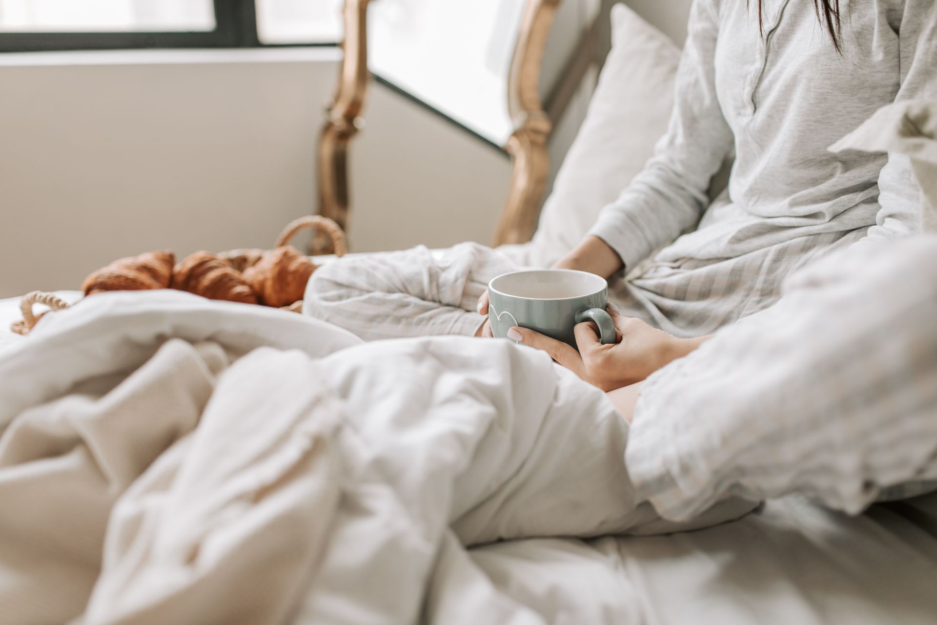 A person relaxing in a cozy bed under warm blankets