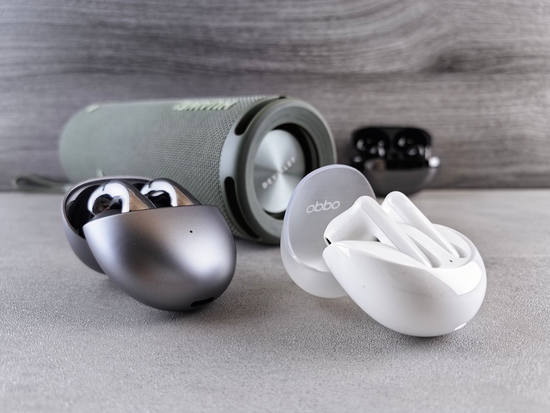 Wireless earbuds next to their charging case