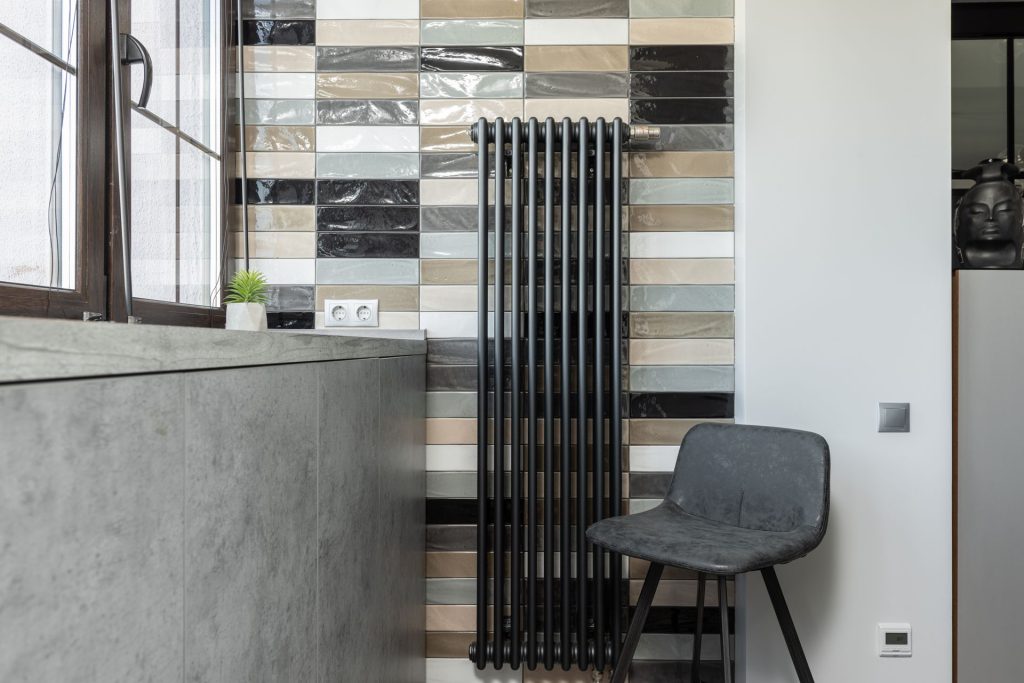 Room interior with a radiator heater and a chair