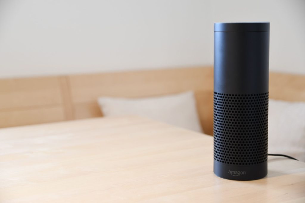 Smart speaker resting on a wooden table at home