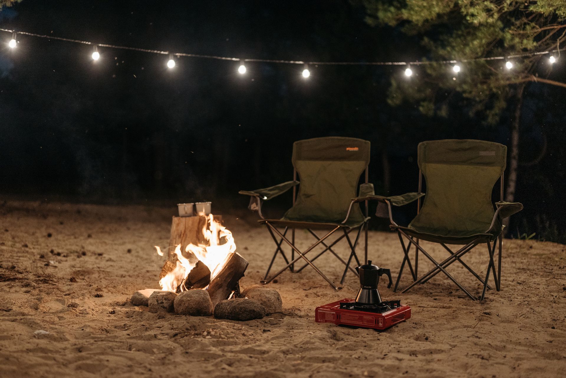 Folding camping chairs set up at a campsite