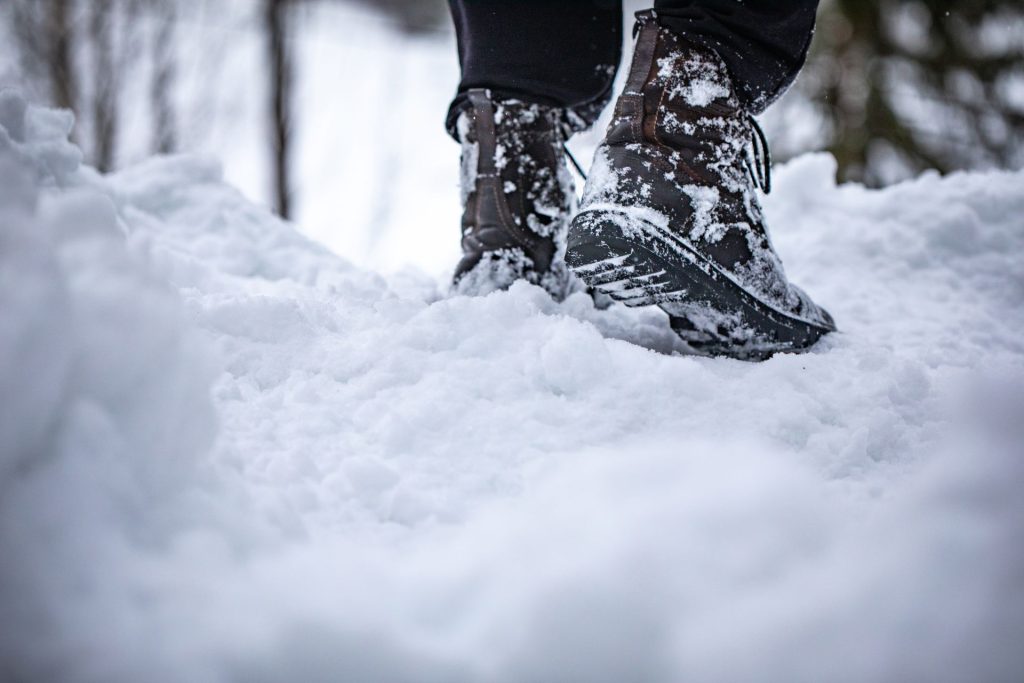 Winter boots stepping through deep snow