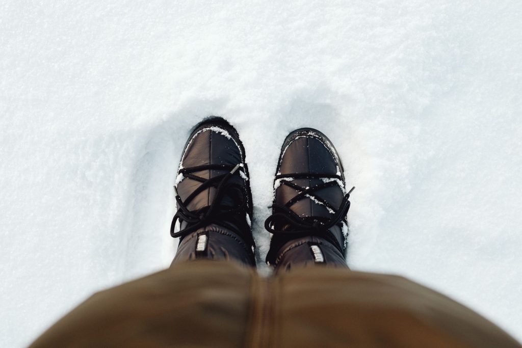 Tall winter boots standing in fresh snow