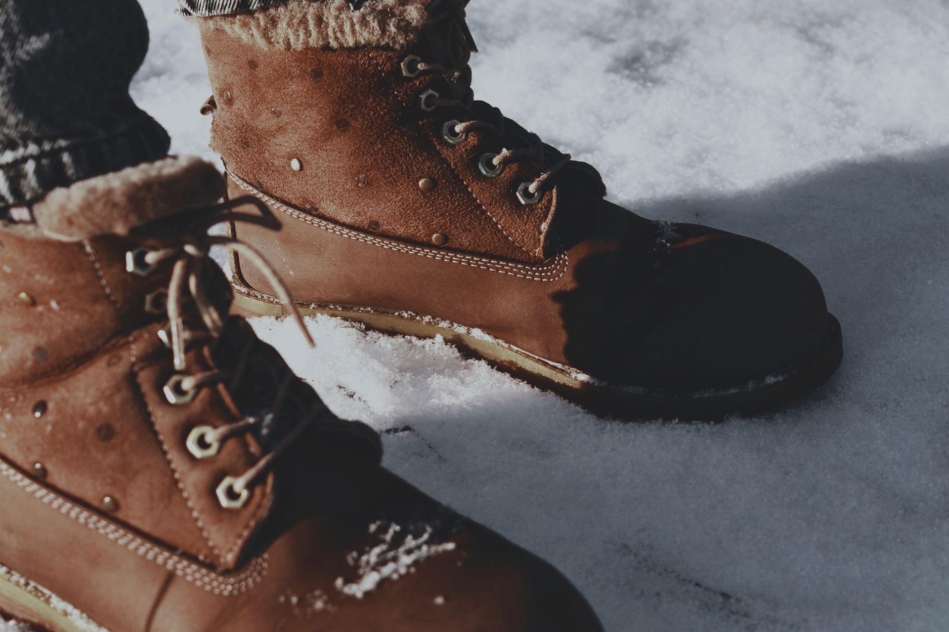 Winter boots in snow for a seasonal deals roundup